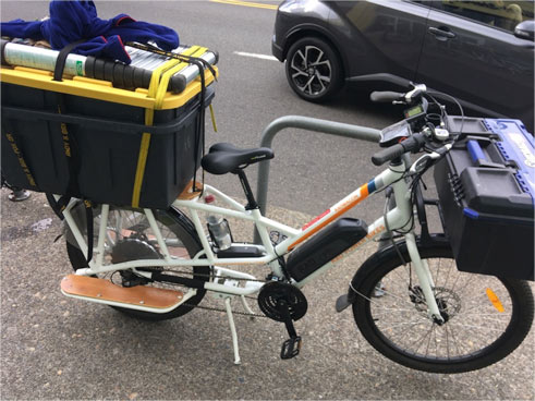 Sunride Electric Bike loaded with supplies for a solar pool heating system