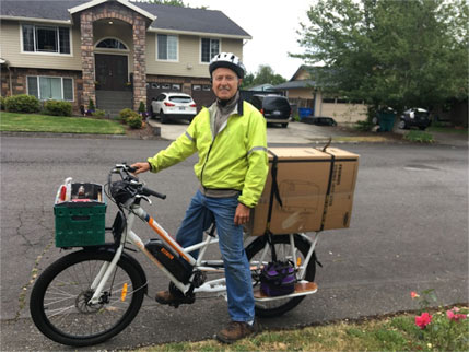 Sunride electric bike with solar inverter strapped on back