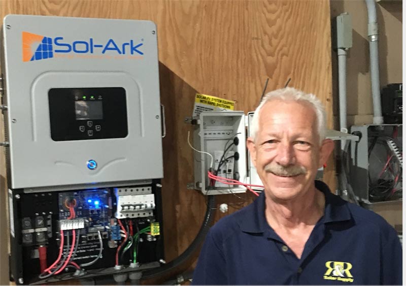 Rolf shows off his combination battery based and grid-tied solar electric system.